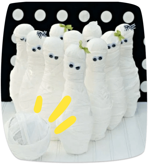 Juego de bolos de Halloween con botellas decoradas como momias y una bola envuelta en papel higiénico.