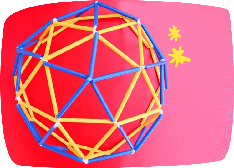 Estructura geodésica hecha con pajitas de colores unidas con plastilina blanca sobre fondo rojo.